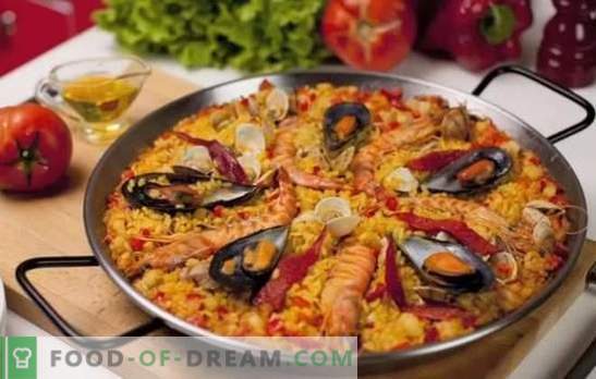 Paella z morskimi sadeži - plov v španskem slogu. Kuhanje paella z morskimi sadeži in fižolom, koruze, grahom, ribami